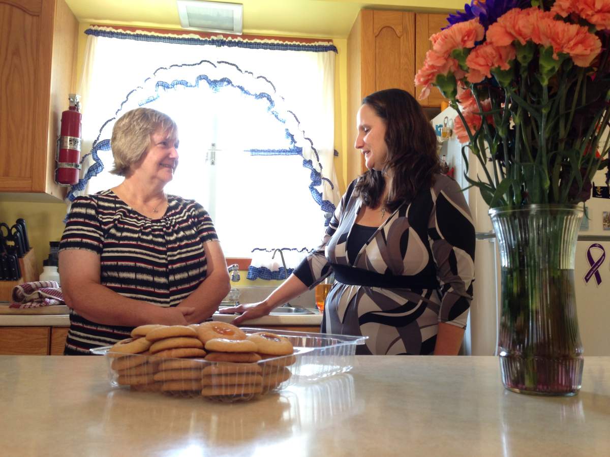 Elta Mullins speaks to family in her home following her mother’s funeral.