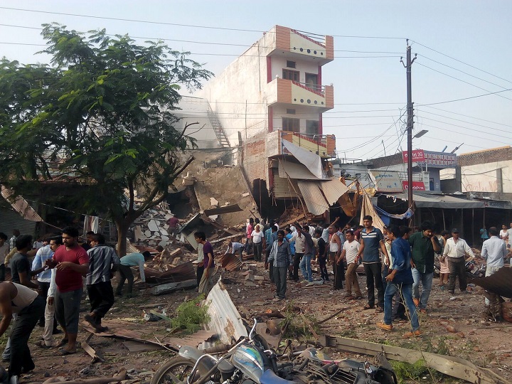 People gather around the site of an explosion at a restaurant in Jhabua district in the central Indian state of Madhya Pradesh on September 12, 2015.