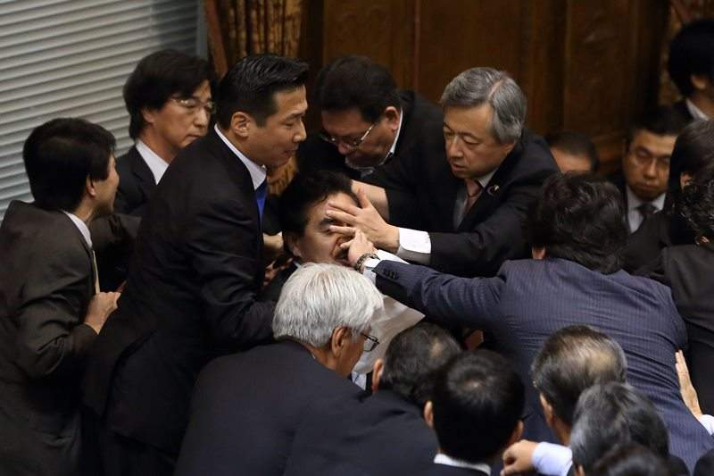 Lawmakers mob around Yoshitada Konoike, chairman of the upper's house special committee on security legislation Fighting breaks out among lawmakers as controversial security bill approved, Tokyo, Japan - 17 Sep 2015.