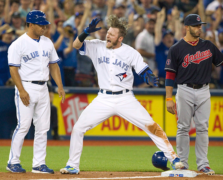 Toronto Blue Jays' Josh Donaldson celebrates after sliding safely into third base with a triple against the Cleveland Indians during fifth inning AL baseball action in Toronto on Monday, August 31, 2015. 