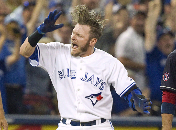 Toronto Blue Jays’ Josh Donaldson celebrates after sliding safely into third base with a triple against the Cleveland Indians during fifth inning AL baseball action in Toronto on Monday, August 31, 2015.