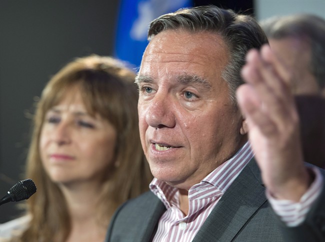 In this 2015 file photo, Quebec CAQ leader François Legault speaks as CAQ MNA Nathalie Roy, left, looks on. Legault confirmed Tuesday that Roy has received threatening letters that she attributed to extremist religious followers, Tuesday, Feb. 21, 2017.