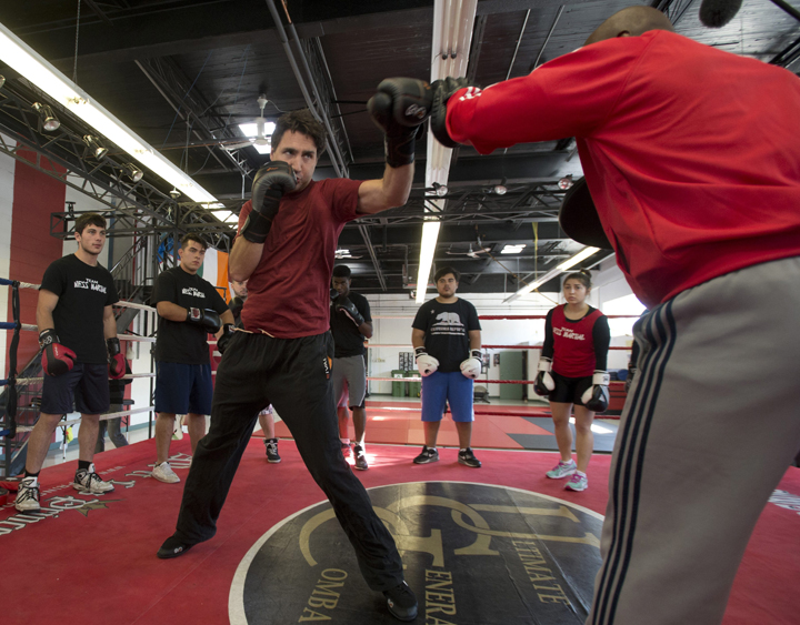 Liberal leader Justin Trudeau boxes with trainer Ali Nestor during a campaign stop in Montreal, Wednesday September 23, 2015. THE CANADIAN PRESS/Adrian Wyld.