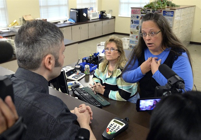 Rowan County Clerk Kim Davis, right, talks with David Moore following her office's refusal to issue marriage licenses at the Rowan County Courthouse in Morehead, Ky., Tuesday, Sept. 1, 2015. Although her appeal to the U.S. Supreme Court was denied, Davis still refuses to issue marriage licenses. (AP Photo/Timothy D. Easley).