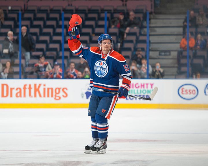 Anton Lander #51 of the Edmonton Oilers salutes the crowed after being selected as the first star of the game following a preseason game against the Arizona Coyotes on September 29, 2015 at Rexall Place in Edmonton, Alberta, Canada. 