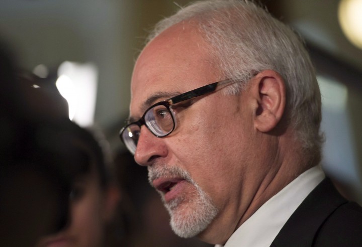 Quebec Finance Minister Carlos Leitao responds to reporters questions after a government caucus meeting, Thursday, June 11, 2015 at the legislature in Quebec City.