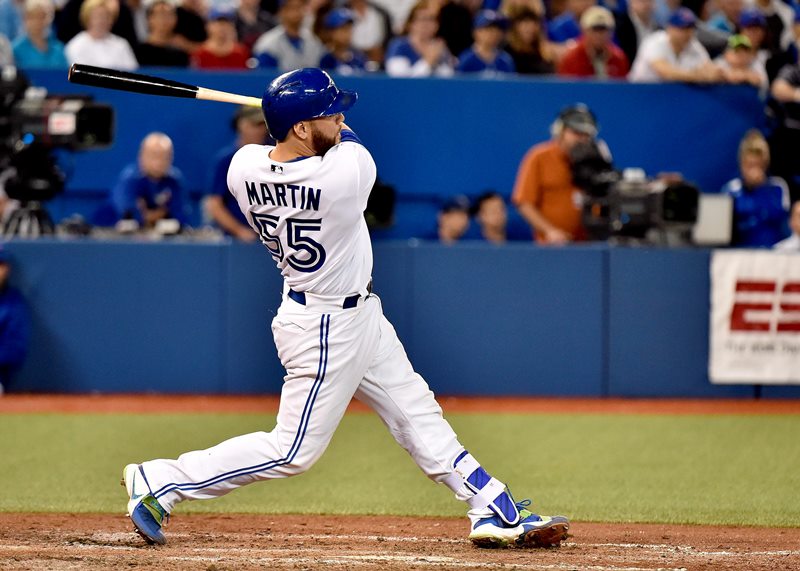Toronto Blue Jays catcher Russell Martin hits a three run home run against the New York Yankees during seventh inning AL baseball action in Toronto on Wednesday, September 23, 2015. 