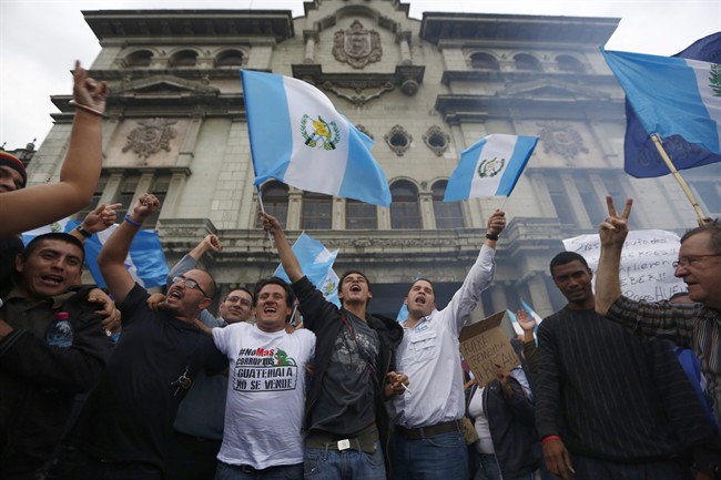 Demonstrators wave Guatemalan flags as they celebrate that Congress voted to withdraw President Otto Perez Molina's immunity from prosecution, in Guatemala City, Tuesday, Sep. 1, 2015. Perez Molina's government has been beset by a series of corruption cases, but until now he has been immune to prosecution as president. (AP Photo Moises Castillo).
