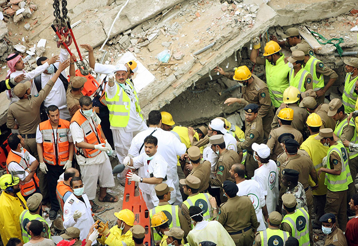 In this Jan. 5, 2006 file photo, rescuers attend to the scene of a building collapse in Mecca, Saudi Arabia. 