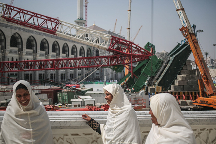 Muslim Pilgrims walk past the site of a crane collapse that killed over a hundred people on Friday at the Grand Mosque in the holy city of Mecca, Saudi Arabia, Tuesday, Sept. 15, 2015. 