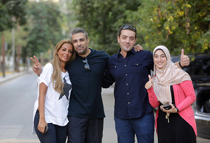 Canadian Al-Jazeera English journalist Mohamed Fahmy second left, and his Egyptian colleague Baher Mohammed, celebrate with their wives after being released from Torah prison in Cairo, Egypt, Wednesday, Sept. 23, 2015.