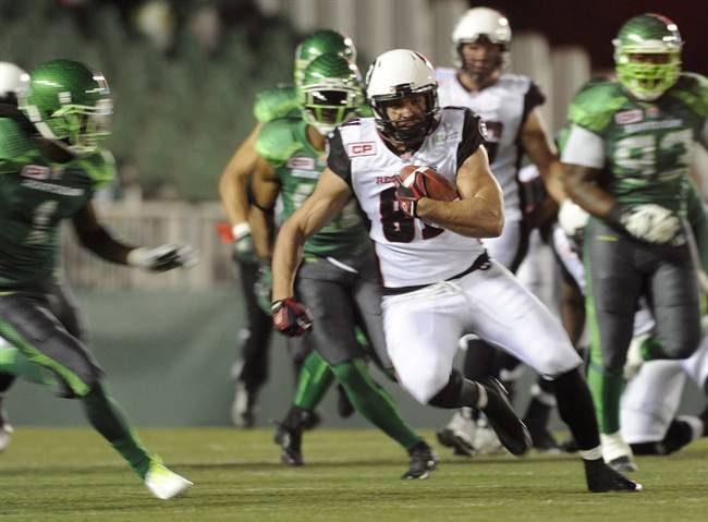Ottawa Redblacks Patrick Lavoie picks up yards against the Saskatchewan Roughriders during first half CFL action in Regina on Saturday, September 19, 2015.
