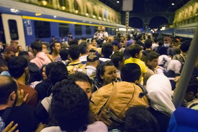 Migrants wait to board a train to Germany at the Keleti Railway Station in Budapest, Hungary, Tuesday, Sept, 1, 2015. (Zoltan Balogh/MTI via AP).