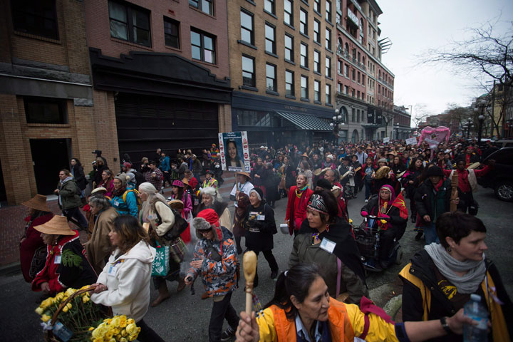 Hundreds of people march through the Downtown Eastside during the 25th annual Women's Memorial March in Vancouver, B.C., on Saturday February 14, 2015. The march is held to honour missing and murdered women and girls from the community with stops along the way to commemorate where women were last seen or found. 