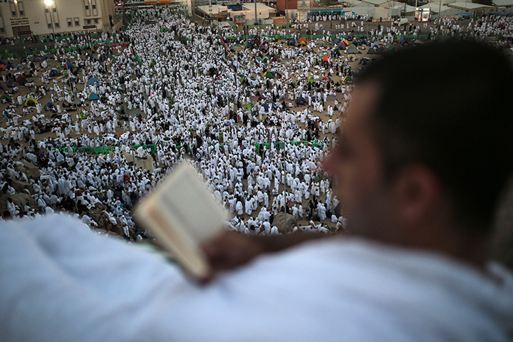 A pilgrim reads the Quran on a rocky hill called the Mountain of Mercy, on the Plain of Arafat, near the holy city of Mecca, Saudi Arabia, Wednesday, Sept. 23, 2015 during the hajj pilgrimage.