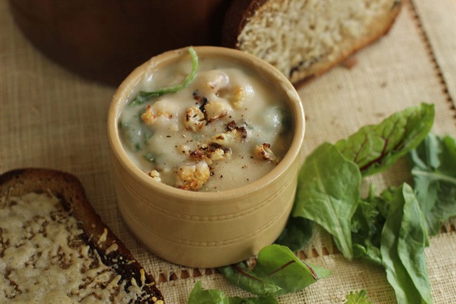 This September 14, 2015 photo shows roasted cauliflower and greens soup with cheesy rye toasts in Concord, NH. 