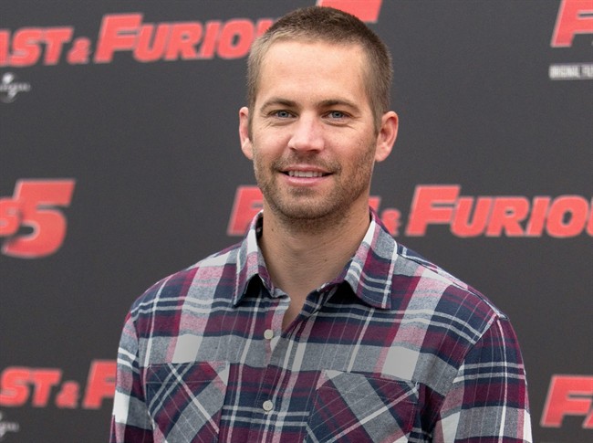 FILE - In this April 29, 2011, file photo, actor Paul Walker poses during the photo call of the movie "Fast and Furious 5," in Rome. Paul Walker’s daughter, Meadow Rain Walker, has filed a lawsuit Monday, Sept. 28, 2015, against Porsche, claiming the sports car that her father was a passenger in when he was killed in late 2013 suffered from numerous design defects. 