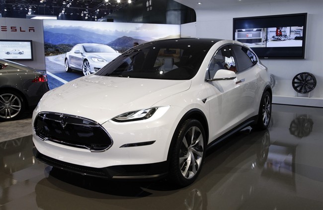  In this Jan. 15, 2013 file photo, the Tesla Model X concept is on display during media previews for the North American International Auto Show in Detroit.