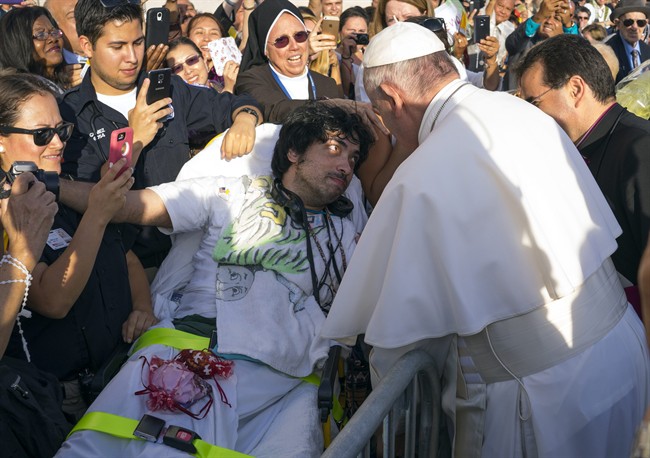 Pope Francis engages well-wishers including Gerard Gubatan, of the Brooklyn borough of New York, center left, after arriving at John F. Kennedy International Airport Thursday, Sept. 24, 2015, in New York. 