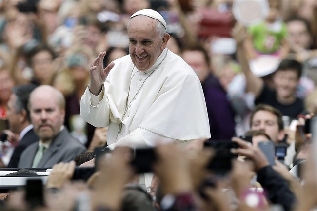 Pope Francis acknowledges faithful as he parades on his way to celebrate Mass Sunday, Sept. 27, 2015, in Philadelphia. (AP Photo/Matt Rourke, Pool).