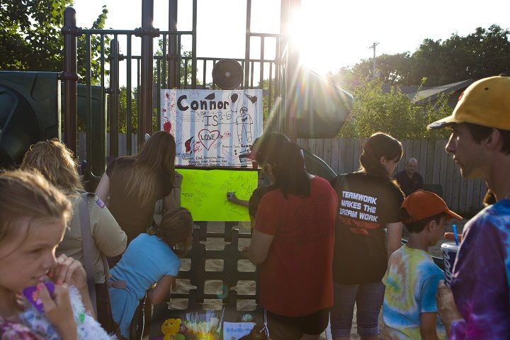 People wait in line to write a note at a memorial for Michael Connor Verkerke, 9, who was stabbed and killed Monday, Aug. 4, in Kentwood, Mich.