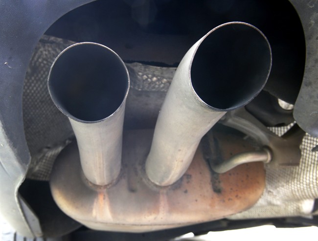 The exhaust of a Volkswagen Passat Bluemotion is photographed in Frankfurt, Germany, Thursday, Sept. 24, 2015. The software at the center of Volkswagen's emissions scandal in the U.S. was built into the automaker's cars in Europe as well, though it isn't yet clear if it helped cheat tests as it did in the U.S., Germany said Thursday. A day after longtime CEO Martin Winterkorn stepped down, a member of Volkswagen's supervisory board said that he expects further resignations at the automaker in the wake of the scandal. (AP Photo/Michael Probst)