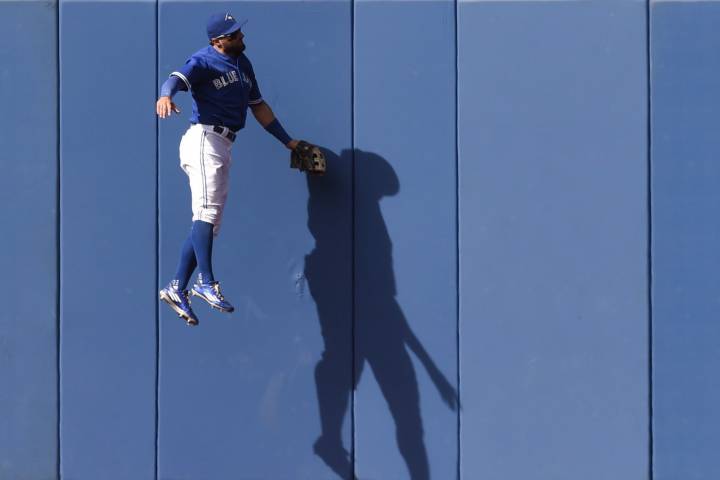 Toronto Blue Jays' Kevin Pillar watches from the wall as a home-run ball from Tampa Bay Rays' Kevin Kiermaier goes out during fourth inning AL MLB action in Toronto on Saturday, Sept. 26, 2015. 
