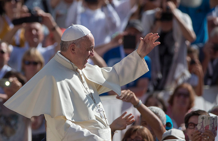 Pope Francis waves as he arrives for his weekly general audience in St. Peter's Square at the Vatican, Wednesday, Aug. 26, 2015. 