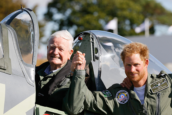Prince Harry poses for a photograph with veteran Tom Neill, left, after he flew in a Spitfire during a Battle of Britain display at Goodwood Aerodrome in West Sussex, England on Tuesday, Sept. 15, 2015. 