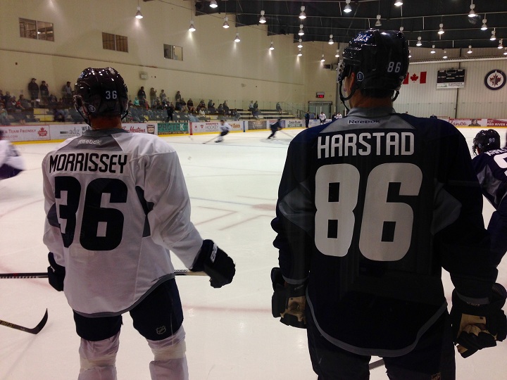 Winnipeg Jets prospects Josh Morrissey and Aaron Harstad watch on during the opening day of rookie camp.