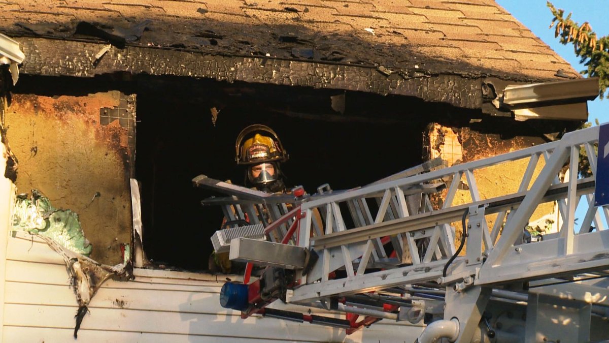 Firefighters battle a blaze along Ranchview Terrace N.W. on Thursday, September 3, 2015.   