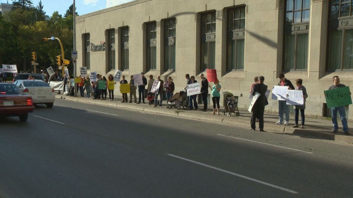 More than 100 people lined Victoria Avenue in downtown Regina to bring awareness to Syrian refugees.