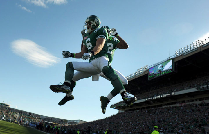 Saskatchewan Roughriders' wide receiver Rob Bagg and Naaman Roosevelt celebrates a touchdown against the Montreal Alouettes during second half CFL action in Regina on Sunday, Sept. 27, 2015.