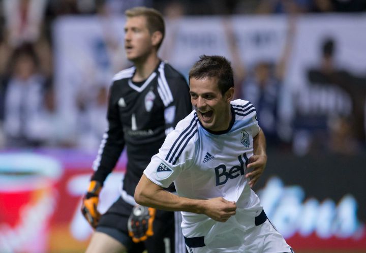 Vancouver Whitecaps' Octavio Rivero, front, of Uruguay, celebrates his goal against Colorado Rapids' goalkeeper Clint Irwin during the second half of an MLS soccer game in Vancouver, B.C., on Wednesday September 9, 2015. 