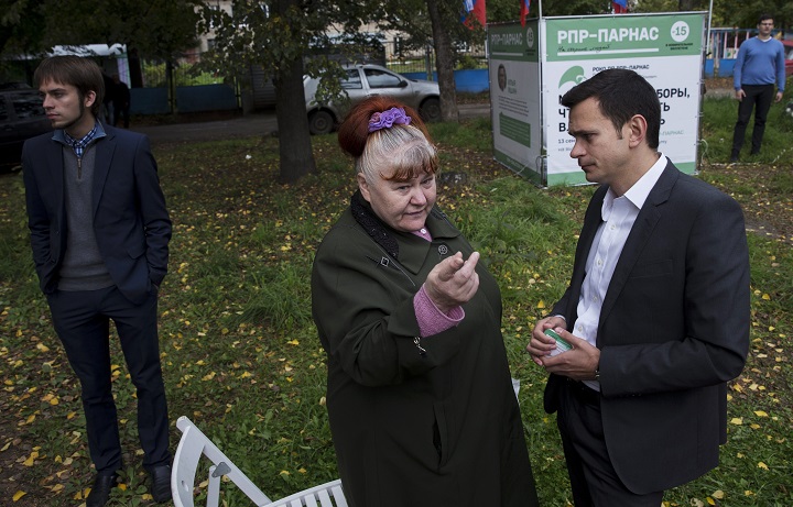 In this photo taken Thursday, Sept. 10, 2015 a local resident talks to Ilya Yashin, right, a democratic opposition candidate after a meeting with the voters in Kostroma, 350 km northeast of Moscow, Russia. Voters will go to polls on Sunday across Russia, but the anti-Putin opposition was allowed to run in only one Russian region, Kostroma.