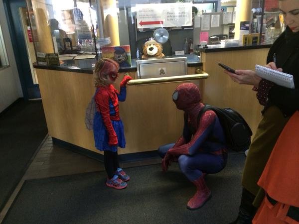 SpiderMable and Spiderman arrive inside police headquarters, Monday, Sept. 28, 2015. 