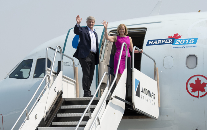 Conservative Leader Stephen Harper and his wife Laureen wave as they board the  party campaign plane after meeting the crew at the airport in Toronto,  Tuesday, September 1, 2015.   
