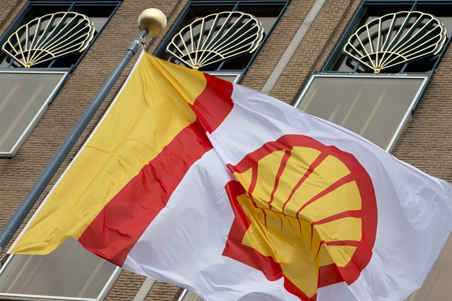 FILE - In this Monday, April 7, 2014 file photo, a flag bearing the company logo of Royal Dutch Shell, an Anglo-Dutch oil and gas company, flies outside the head office in The Hague, Netherlands. 