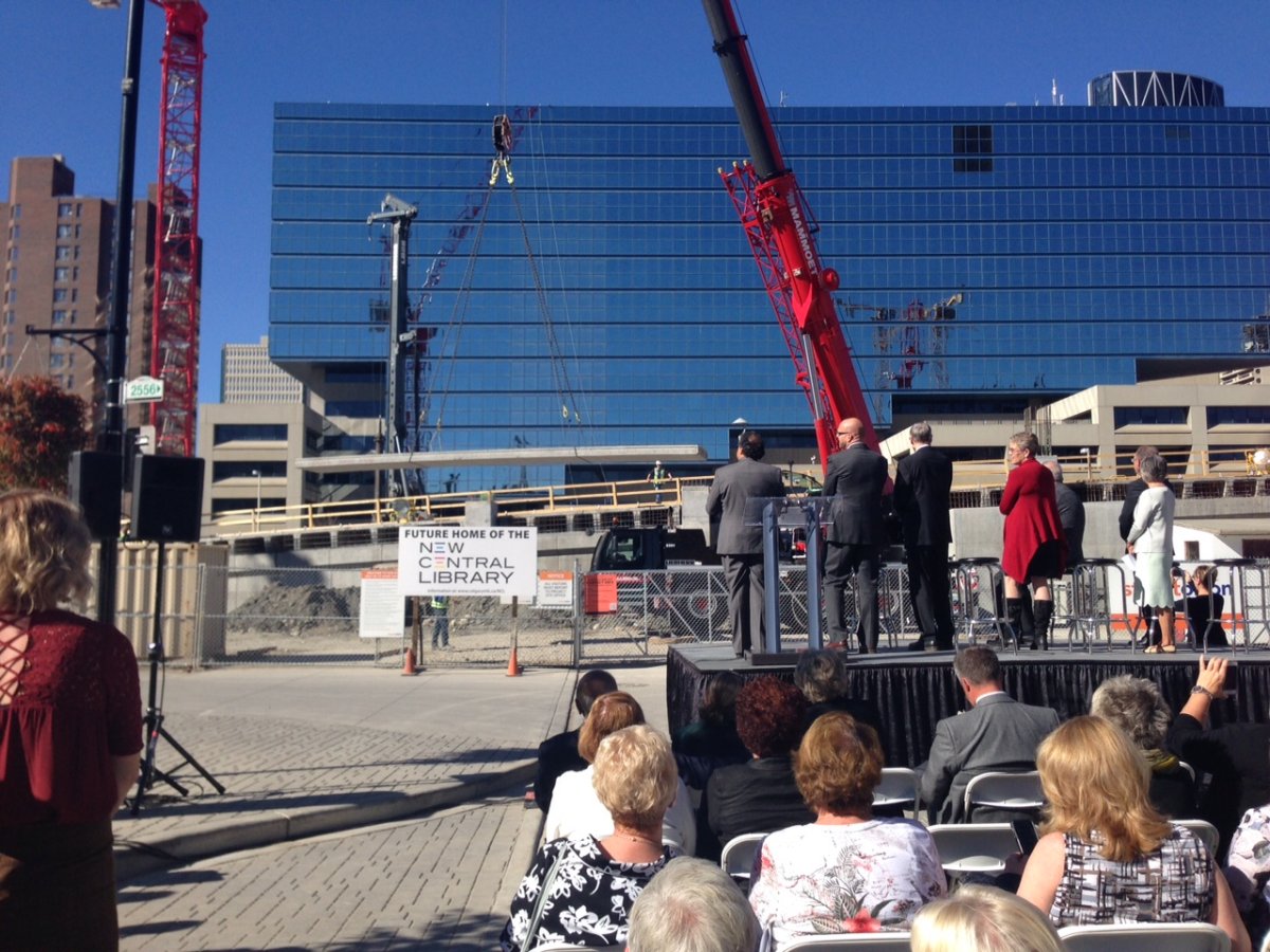 City of Calgary officials applaud as completion of phase one of the new central library construction is marked on September 30, 2015.