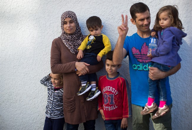 Syrian refugees who came to Canada last December, Hanan Alawwad, second left, and her husband Samer Aldhmad stand with their children Nour Aldhmad, 4, from left to right, Omar Aldhmad, 1, Ayman Aldhmad, 7, and Nawwar Aldhmad, 3.