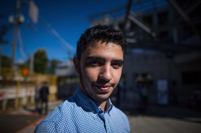 Majd Agha, 22, a Syrian refugee who came to Canada by himself in 2014, poses for a photograph in Vancouver, B.C., on September 10, 2015. Agha wasn't sure what he would say to a crowd of reporters gathered outside a newcomer centre under construction in Vancouver.