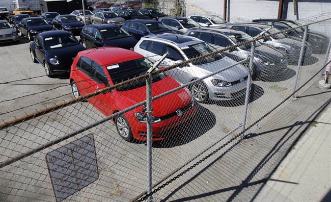FILE - In this Sept. 23, 2015 file photo, diesel Volkswagens are seen behind a security fence on a storage lot near a VW dealership in Salt Lake City. Volkswagen is far from the first company to stand accused of trying to game required emissions tests. Almost since the passage of the Clean Air Act in 1970, major manufacturers of cars, trucks and heavy equipment have been busted for using what regulators call “defeat devices” _ typically programing a vehicle’s on-board computer to boost horsepower or fuel mileage by belching out dirtier exhaust than allowed. (AP Photo/Rick Bowmer, File).