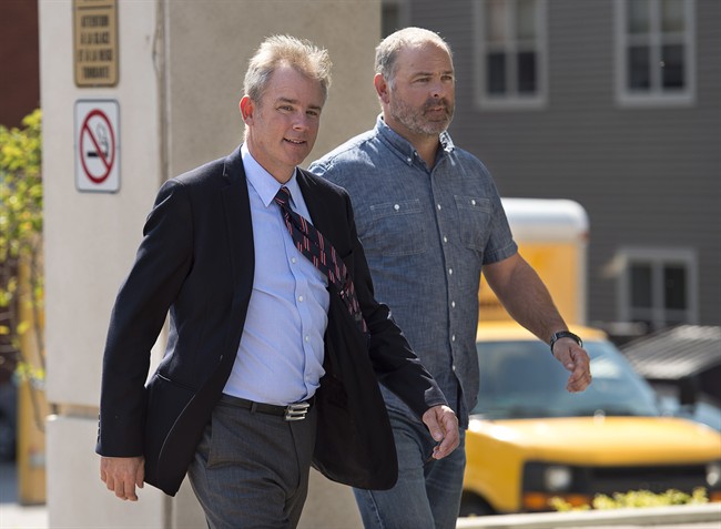 Dennis Oland walks with an unidentified friend at his trial in Saint John, N.B. on Wednesday, Sept. 16, 2015.