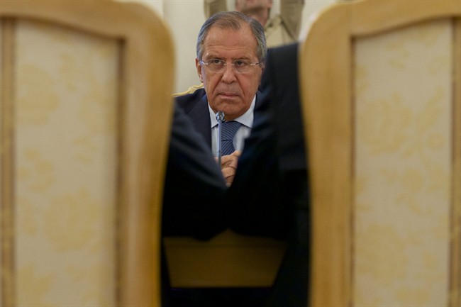 Russian Foreign Minister Sergey Lavrov listens to his counterparts Ibrahim Gandour, from Sudan, left, and Benjamin Barnaba, from South Sudan, right, during their trilateral meeting in Moscow, Russia, on Thursday, Sept. 10, 2015. 