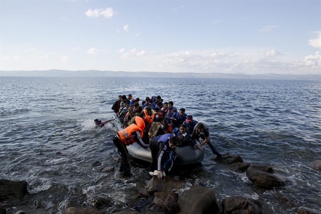 Afghan migrants arrives on the shores of the Greek island of Lesbos after crossing the Aegean sea from Turkey on a inflatable dinghy, Thursday, Sept. 24, 2015.