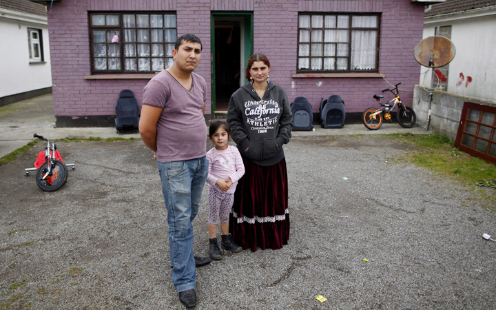 Iancu Muntean, left, and Loredana with their daughter Regina outside their home in Meadowbrook Estate Athlone, Ireland, Thursday, Oct. 24, 2013. The family were left shaken after Irish police took their other child Iancu (2) away and later returned him following DNA testing to confirm that they were his parents. 