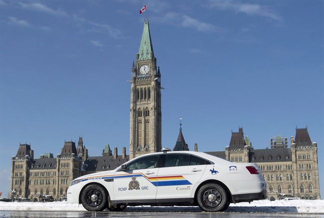 An RCMP police car sits outside the Parliament buildings on Parliament Hill in Ottawa, Friday, February 6, 2015.