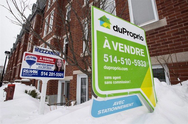 For sale signs are seen in front of a Montreal condominium.