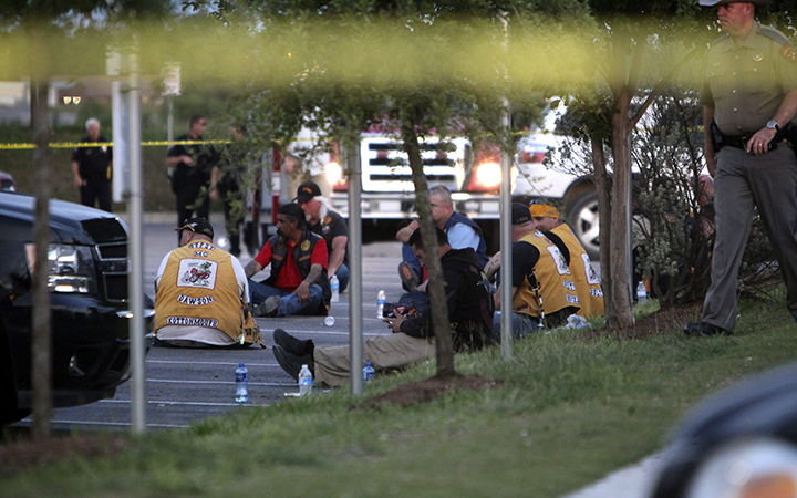 Police detain and watch members of various motorcycle clubs outside the Twin Peaks restaurant in Waco, Texas, Sunday, May 17, 2015. 