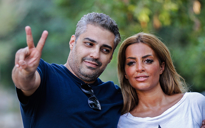 Recently released Mohammed Fahmy gives the peace salute while posing with his wife, Marwa Omara in Cairo, Egypt, on September 23, 2015. 